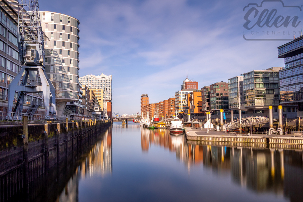 Harbour Harmony | In Hamburg’s HafenCity, glass and brick, cranes and calm water create a modern rhythm of reflection. The iconic Elbphilharmonie rises in the distance — a symbol of how tradition and innovation can flow together in perfect balance. - Realisiert mit Pictrs.com