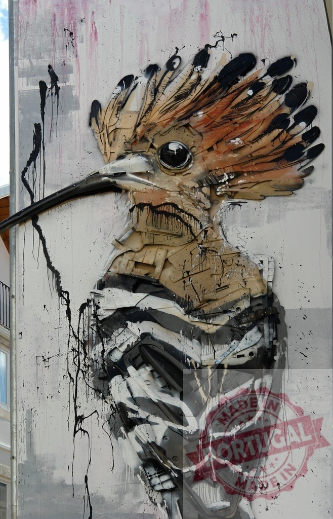 Bordalo II hoopoe bird street art from trash | Environmental art sculpture of a hoopoe bird crafted from recycled waste materials on an urban wall - Realized with Pictrs.com