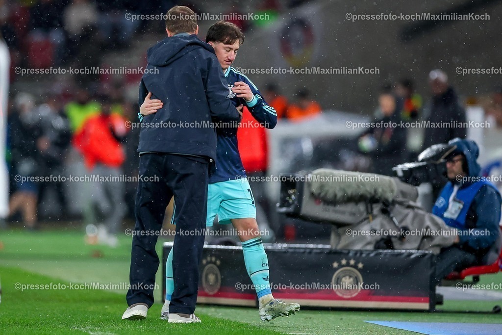 DFB30032600074 | 30.03.2026, Fußball, Länderspiel, Deutschland - Ghana, MHP-Arena (Stuttgart), Saison 2025 2026: Angelo Stiller (GER #16)  neben Nationaltrainer Julian Nagelsmann (GER Bundestrainer) bei der Auswechslung DFB regulations prohibit any use of photographs as image sequences and or quasi-video.