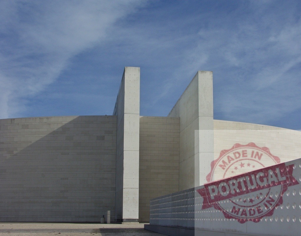 Modern concrete building with curved wall and blue sky | Modern concrete building with curved wall under blue sky and clouds - Realized with Pictrs.com