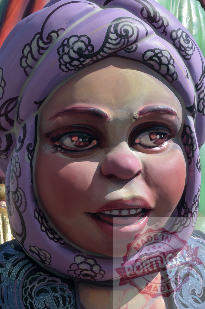 Fallas festival sculpture of woman in purple head covering. Fallas Fiestas Communidad Valenciana | Fallas festival sculpture depicting a woman with a purple head covering and open mouth - Realized with Pictrs.com