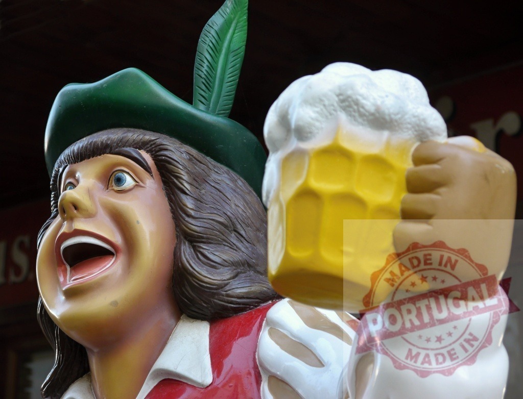 Traditional Bavarian man statue holding a beer mug | Cheerful male statue with a feathered hat celebrating with a foamy beer mug - Realized with Pictrs.com