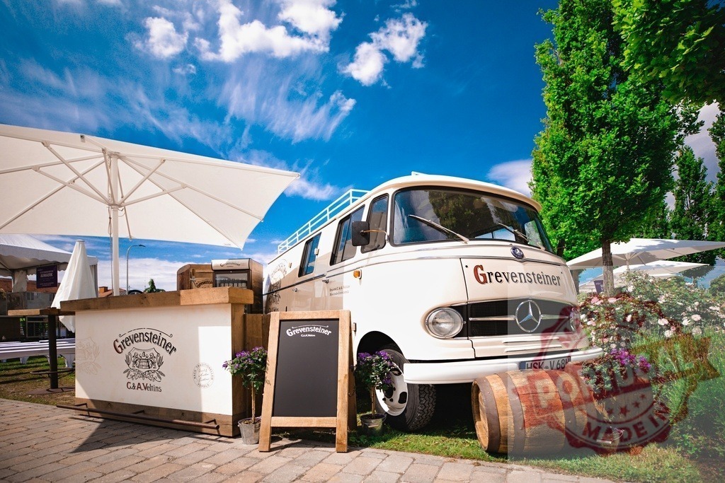 Grevensteiner mobile bar vintage Mercedes-Benz van at outdoor event | Grevensteiner vintage Mercedes-Benz van operating as a mobile bar at an outdoor summer event - Realisiert mit Pictrs.com