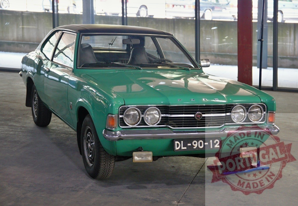 Green Ford Cortina GXL parking in exhibition hall | Shiny green Ford Cortina GXL parked on grey floor in exhibition hall, showing front view - Realized with Pictrs.com