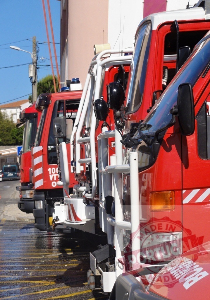 Red fire trucks parked ready for emergency response | Red fire trucks from Bombeiros department lined up, ready for rescue and assistance - Realized with Pictrs.com