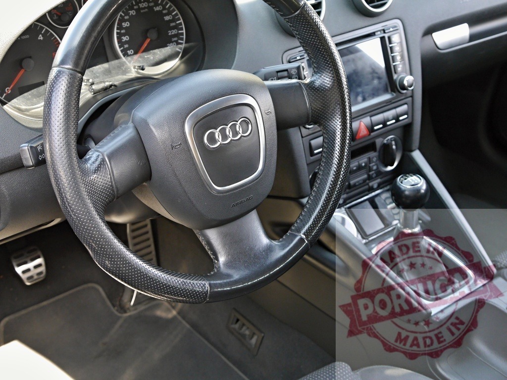 Audi A3 interior showing steering wheel and manual gear stick | Audi A3 car interior detailing the steering wheel, dashboard, and manual transmission - Realized with Pictrs.com
