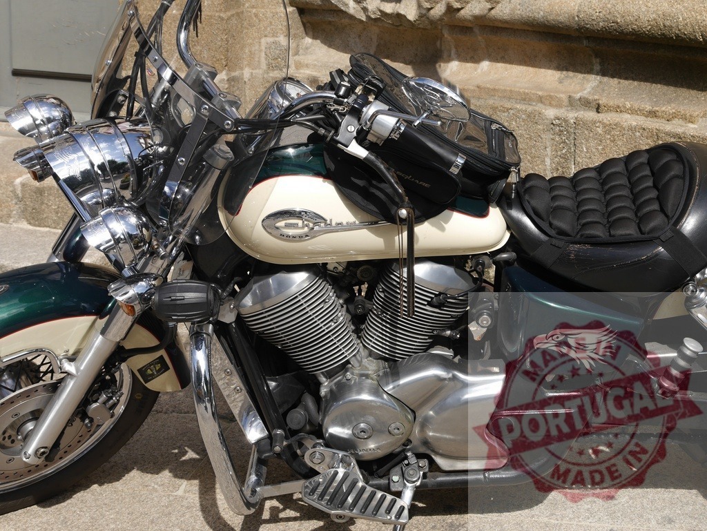 Powerful Honda Shadow motorbike parked near stone wall | Gleaming Honda Shadow motorbike with an eagle sticker parked near a stone wall, showcasing its chrome details and powerful engine - Realized with Pictrs.com