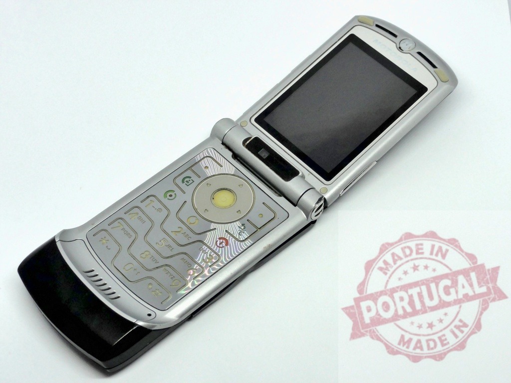 Motorola RAZR V3 opened and showing keyboard lying on white background | Old mobile phone Motorola RAZR V3 opened and showing keyboard lying on white background - Realized with Pictrs.com
