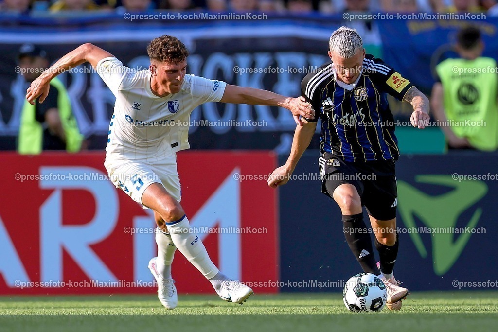DFB15082501026 | 15.08.2025, Fußball, DFB-Pokal, 1. FC Saarbrücken - 1.FC Magdeburg, Ludwigsparkstadion, Saison 2025 2026: Tobias Müller&nbsp;(1FC Magdeburg #05) im Zweikampf gegen  Florian Pick&nbsp;(1FC Saarbruecken #20)   DFB regulations prohibit any use of photographs as image sequences and or quasi-video.