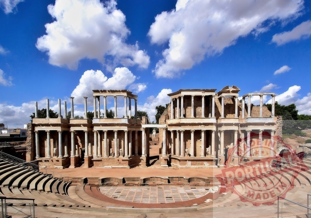 Roman Theatre of Merida ancient architecture landmark in Spain. Spain - Extremadura | Ancient Roman Theatre of Merida showcasing classical architecture and archaeological ruins under a blue sky - Realized with Pictrs.com