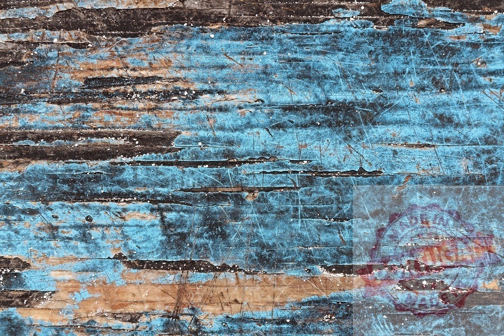 Weathered blue painted wood showing signs of age and distress | Close-up of distressed, weathered blue painted wood, revealing texture and scratches, ideal for backgrounds and rustic designs - Realized with Pictrs.com