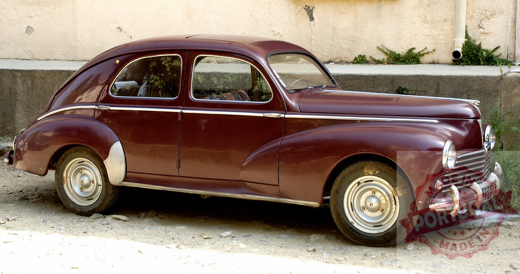 Classic Peugeot 203 parked near a wall in a sunny day | Burgundy Peugeot 203 parked near a wall is showing its classic design - Realisiert mit Pictrs.com