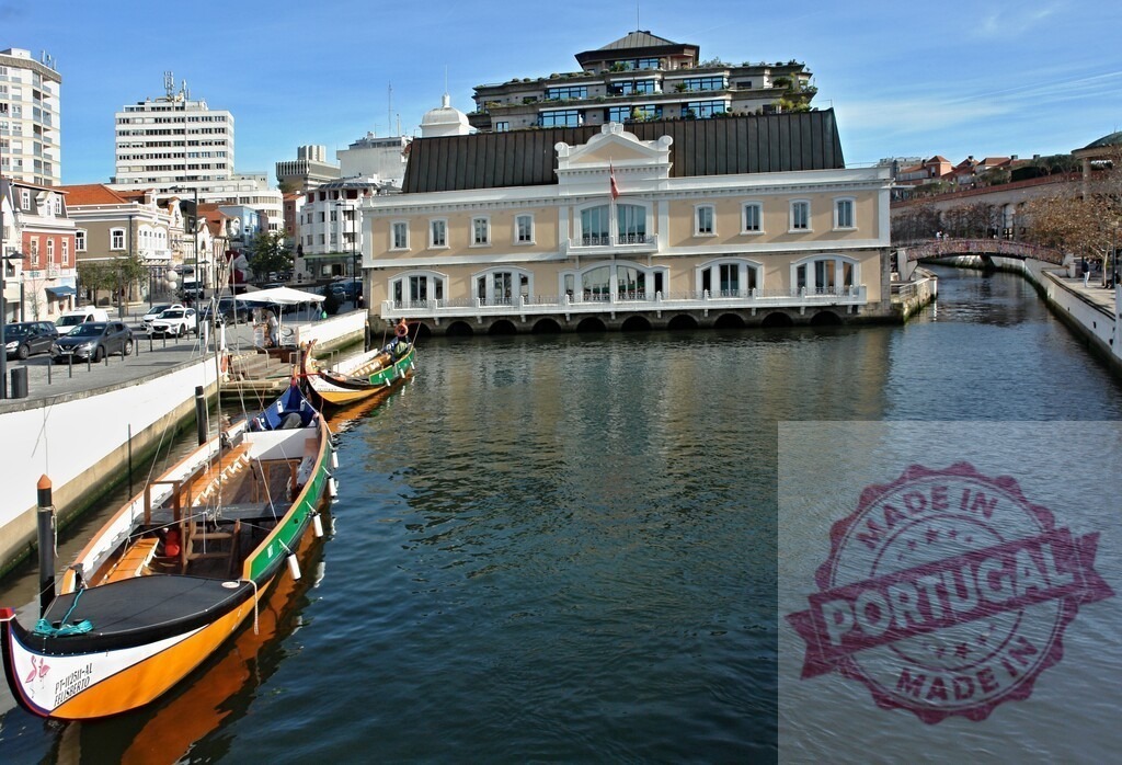 Moliceiro boats moored on a canal in Aveiro, Portugal | Colorful traditional moliceiro boats moored along an urban canal under a clear blue sky - Realisiert mit Pictrs.com