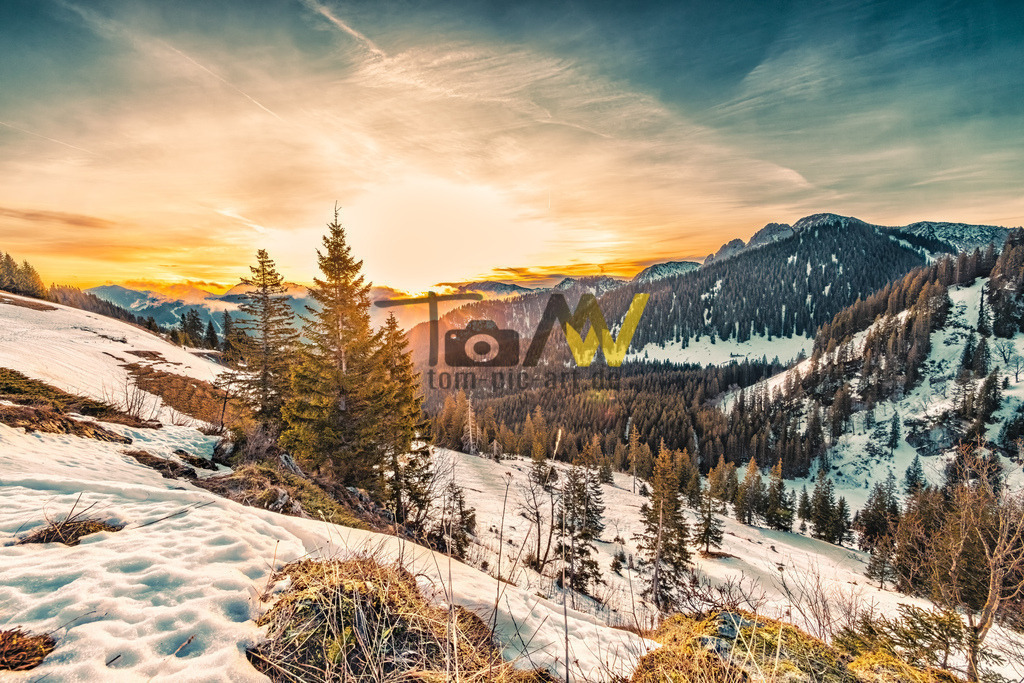 Traumhafter Sonnenaufgang über die Alpen---------Tegernsee | Früh morgentlicher Sonnenaufgang über die verschneiten Berge des Tegernsee. Das Bild zeigt einen winterlichen Sonnenaufgang in den Bayerischen Voralpen. Es zeigt eine idyllische Landschaft in der Region Tegernsee. Die Szene fängt ein, wie die Morgensonne durch die kalte Bergluft dringt.  - Realisiert mit Pictrs.com