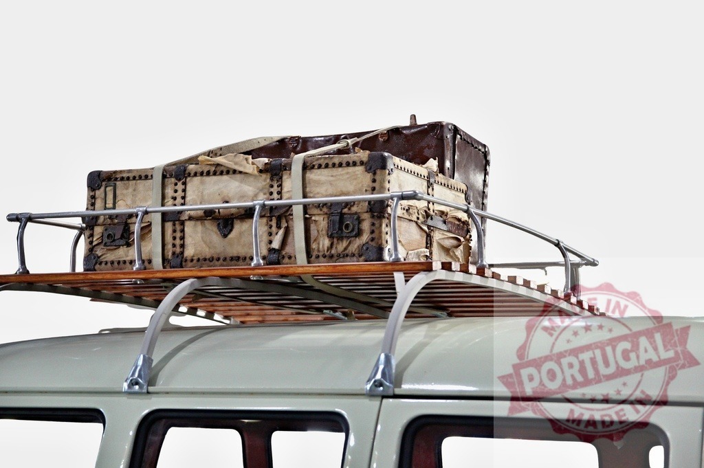 Old suitcase on roof rack of vintage van evoking travel and adventure | Old suitcase secured on the roof rack of a vintage van, symbolizing travel, adventure, and wanderlust - Realized with Pictrs.com
