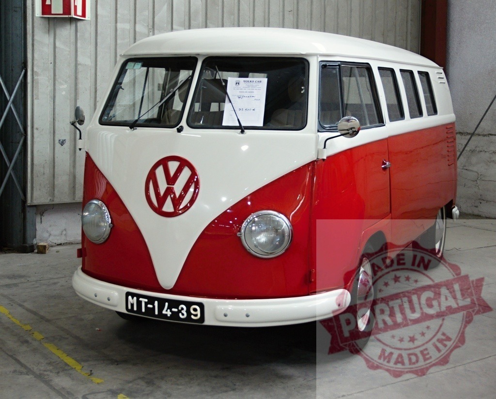 Classic Volkswagen Kombi Van parked indoors showing its front | Red and white vintage Volkswagen Kombi van parked indoors in a garage - Realized with Pictrs.com