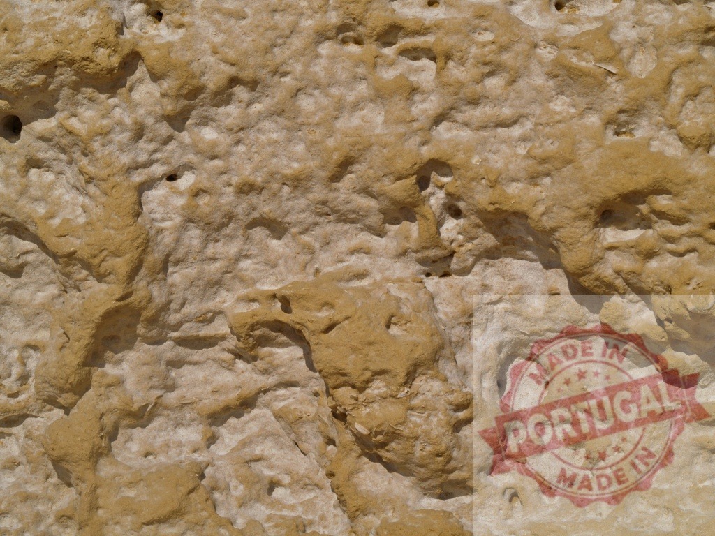 Porous limestone rock face creating an uneven textured surface | Close-up view of a weathered porous limestone rock face, showcasing its uneven texture and natural formation - Realisiert mit Pictrs.com