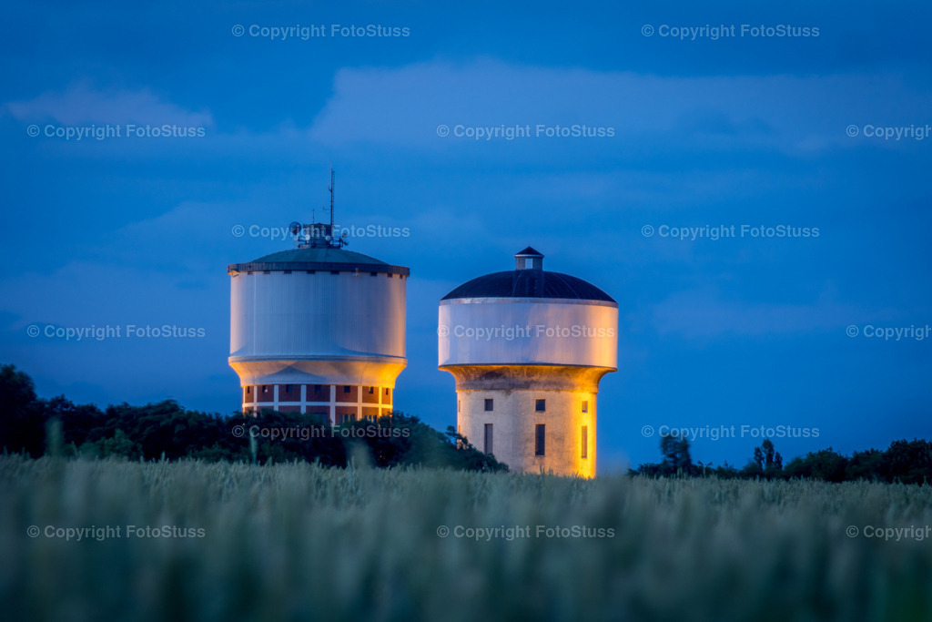 Wassertürme Hamm-Berge | Die Wassertürme in Hamm-Berge zur blauen Stunde mit einem Kornfeld als Vordergrund. - Realisiert mit Pictrs.com