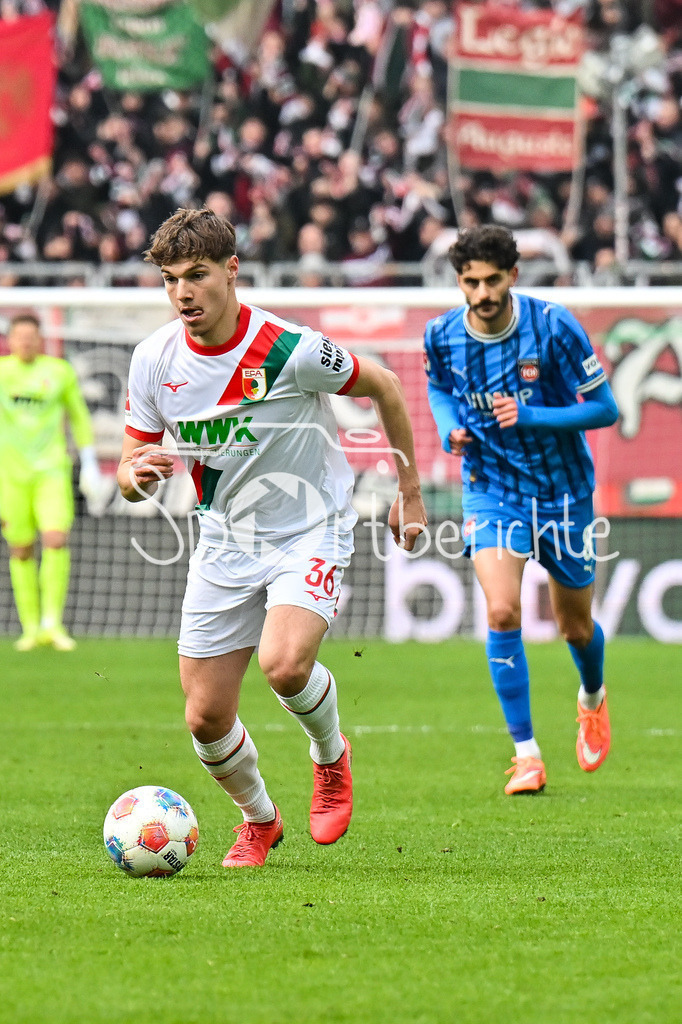 FC Augsburg - 1. FC Heidenheim | AUGSBURG, GERMANY - 15. FEBRUARY: am Ball Mert KOEMUER (KÖMÜR, KOMUR, FC Augsburg 36) während dem Bundesligamatch zwischen dem FC Augsburg und dem 1. FC Heidenheim am 22. Spieltag in der WWK-Arena / DFL REGULATIONS PROHIBIT ANY USE OF PHOTOGRAPHS AS IMAGE SEQUENCES AND/OR QUASI-VIDEO
