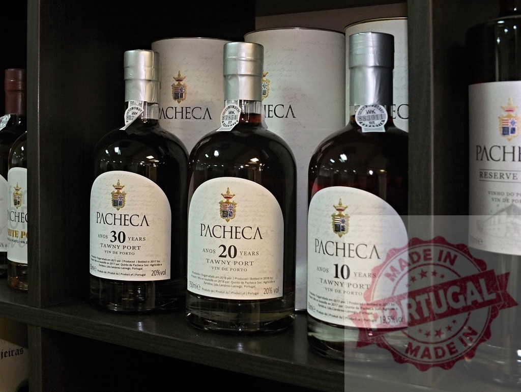 Pacheca Tawny Port wine bottles on cellar shelf | Pacheca Tawny Port wine bottles, 10, 20, 30 years, standing on a dark wooden shelf - Realized with Pictrs.com