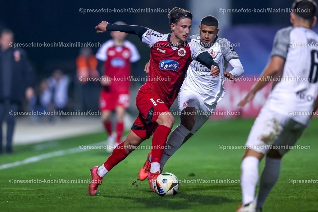 Koe12032501038 | 12.03.2025, Fußball, FC Viktoria Köln – Rot-Weiss Essen, 3.Liga, Sportpark Höhenberg, Saison 2024 2025: Jonah Sticker (Viktoria Köln #33) im Zweikampf gegen Jimmy Kaparos (RWE #8)DFB regulations prohibit any use of photographs as image sequences and or quasi-video.