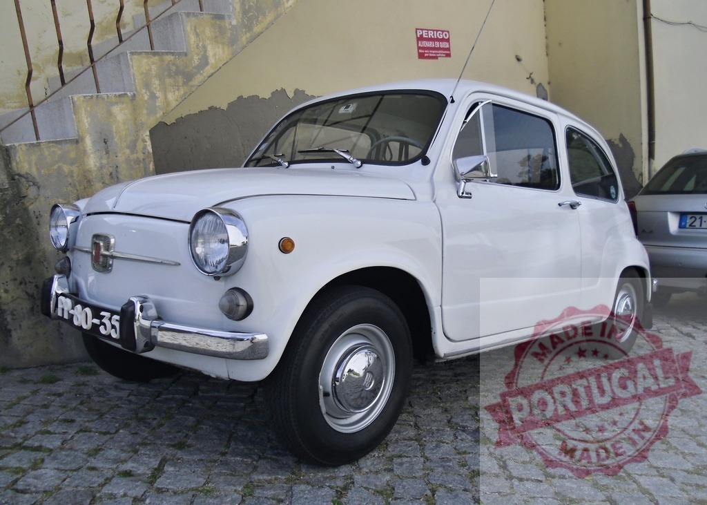 White Fiat 600 vintage car parked on European cobblestone street | Classic Fiat 600 automobile parked on a traditional cobblestone street in a historic city - Realized with Pictrs.com