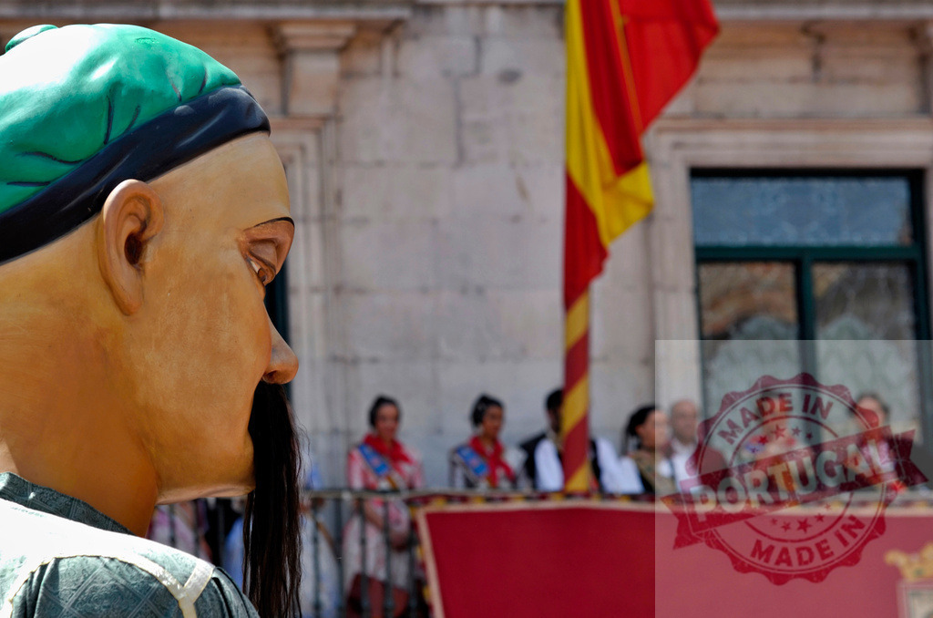 Giant figure parading during a Spanish festival celebration. Spain - Burgos | Giant human figure participating in a traditional cultural celebration under the Spanish flag - Realized with Pictrs.com