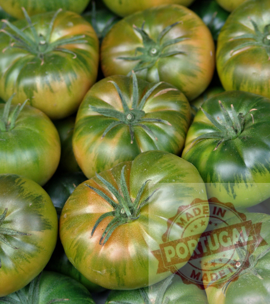 Green zebra heirloom tomatoes background with vibrant stripes | Green zebra heirloom tomatoes displaying unique stripes and fresh vibrant colors - Realized with Pictrs.com