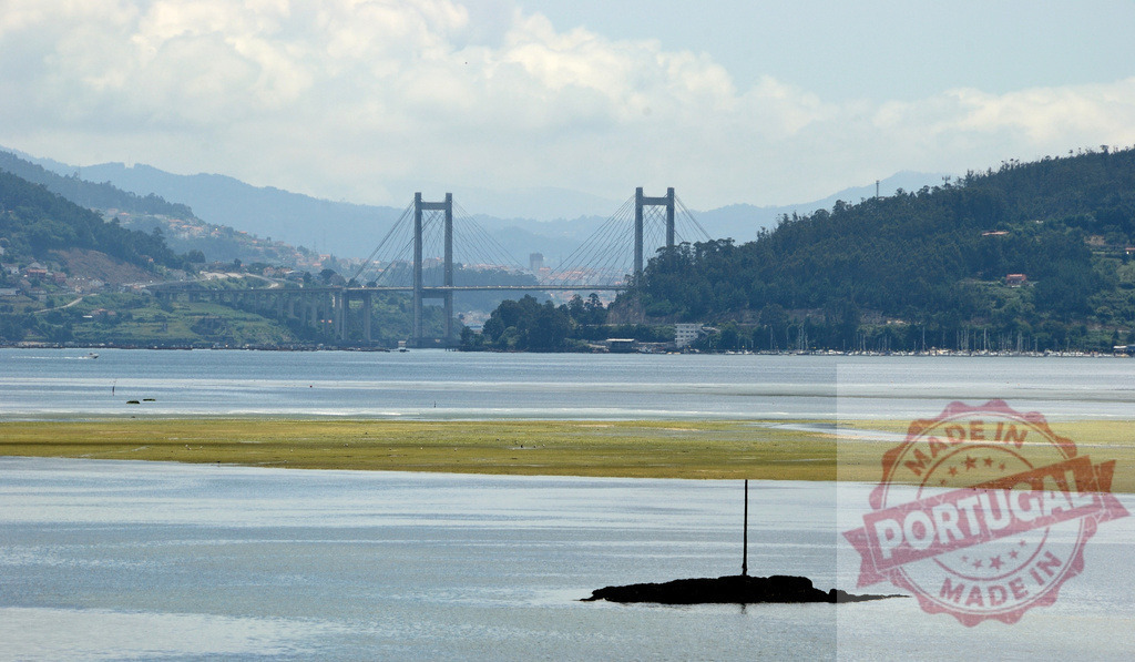 Rande Bridge spanning Ria de Vigo estuary in Galicia, Spain. Galicia - Spain | Rande Bridge connecting across the tranquil estuary with mountains and landscape in the background - Realisiert mit Pictrs.com