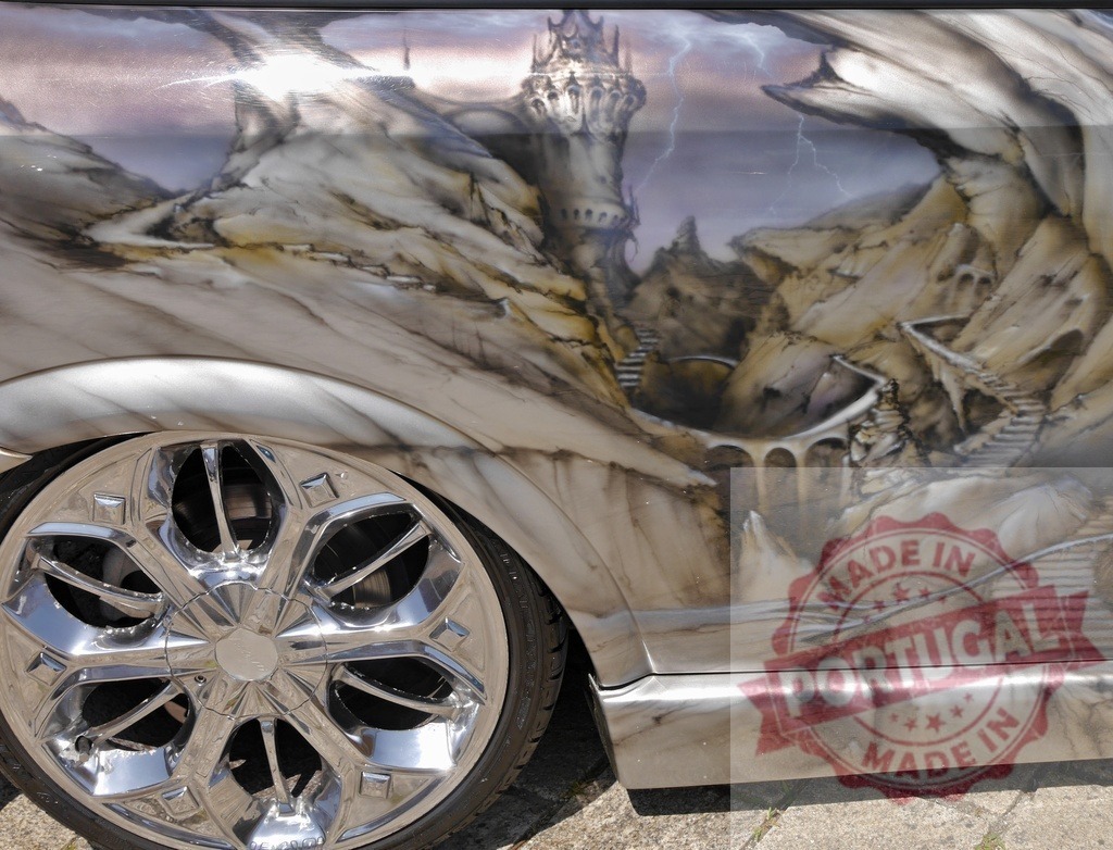 Custom car airbrush painting fantasy castle landscape | Custom car featuring fantasy castle landscape airbrush artwork with chrome wheel - Realized with Pictrs.com
