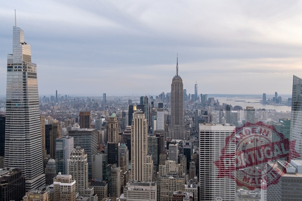 New York City skyline featuring Empire State Building and Bank of America Tower | Breathtaking aerial view of Midtown Manhattan, showcasing iconic skyscrapers and urban cityscape under a cloudy sky - Realized with Pictrs.com
