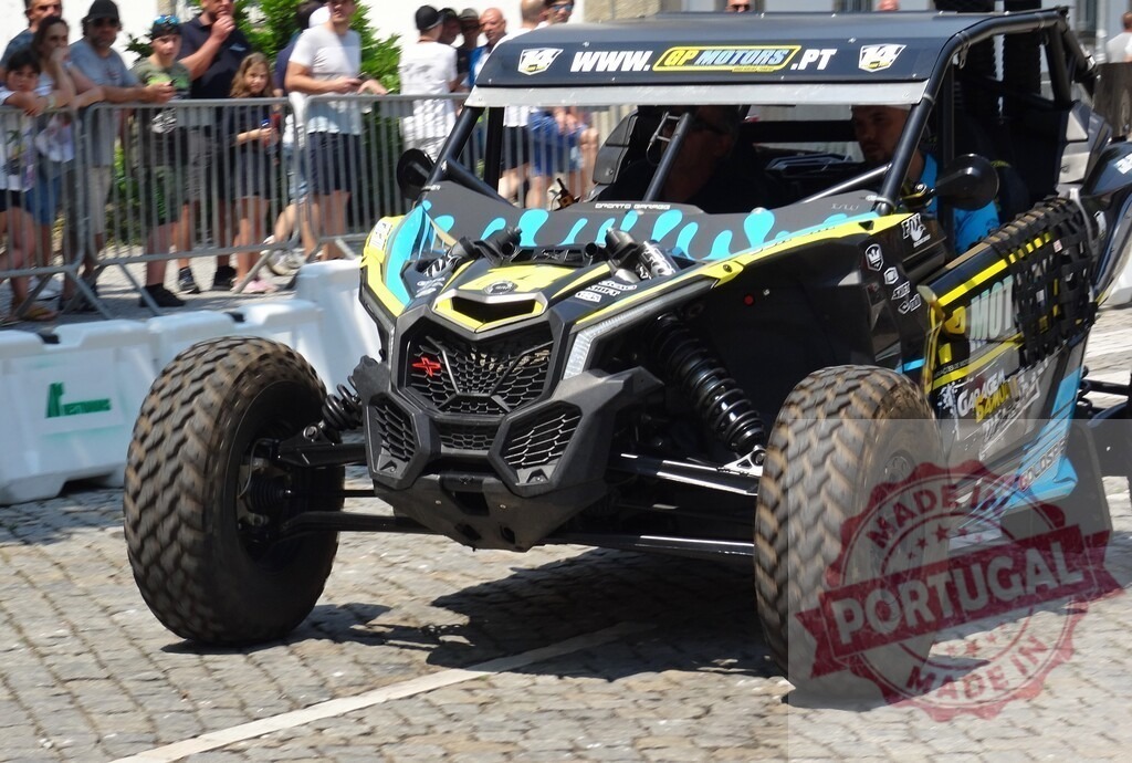 Can-Am Maverick X3 racing through city streets, thrilling spectators | Powerful Can-Am Maverick X3 buggy navigating a city course, captivating onlookers with its speed and agility - Realized with Pictrs.com