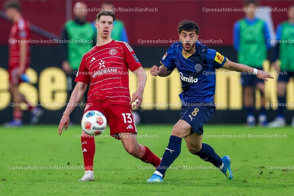 F9510042601080 | 10.04.2026, Fußball, Fortuna Düsseldorf - Holstein Kiel, 2. Fußball Bundesliga, Herren, Merkur Spiel-Arena, 29. Spieltag, Saison 2025 2026: Cedric Itten&nbsp;(Fortuna Düsseldorf #13) im Zweikampf gegen  Umut Tohumcu&nbsp; (Holstein Kiel #08)  DFB regulations prohibit any use of photographs as image sequences and or quasi-video.