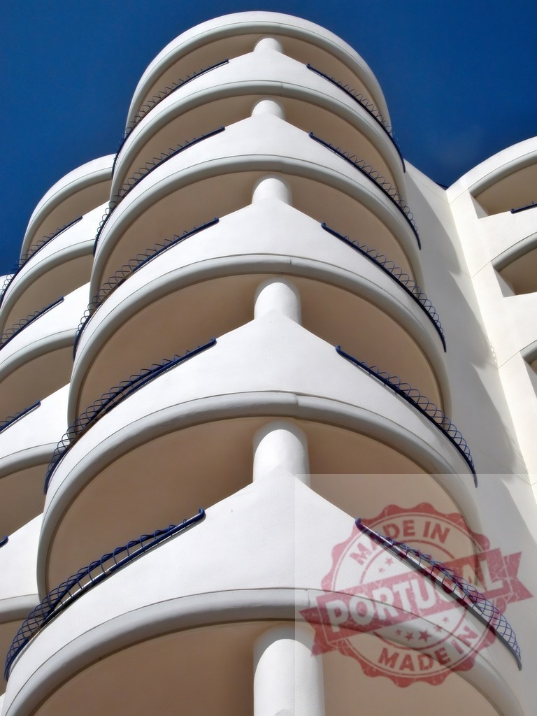 White curved building balconies and blue sky. Espana - Cadiz | Modern white building with repeating curved balconies and vivid blue sky - Realized with Pictrs.com