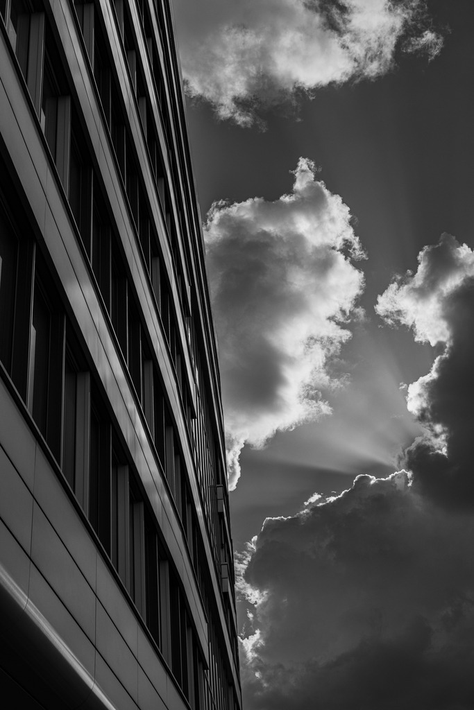 Black White Architecture Print, Dramatic Sky Urban Photography, Minimalist Office Wall Art | Bring dramatic contrast and urban atmosphere into your space with this black and white architecture print.This fine art photograph captures the striking meeting point between modern architecture and a powerful sky, creating a bold and minimalist wall art piece for contemporary interiors.Perfect for:modern living roomsoffices and workspacesminimalist interiorsarchitecture loversblack and white gallery wallsPrinted from an original fine art photograph by RU Fotografie, this artwork is designed to add structure, mood, and timeless urban character to your wall decor. - Realisiert mit Pictrs.com