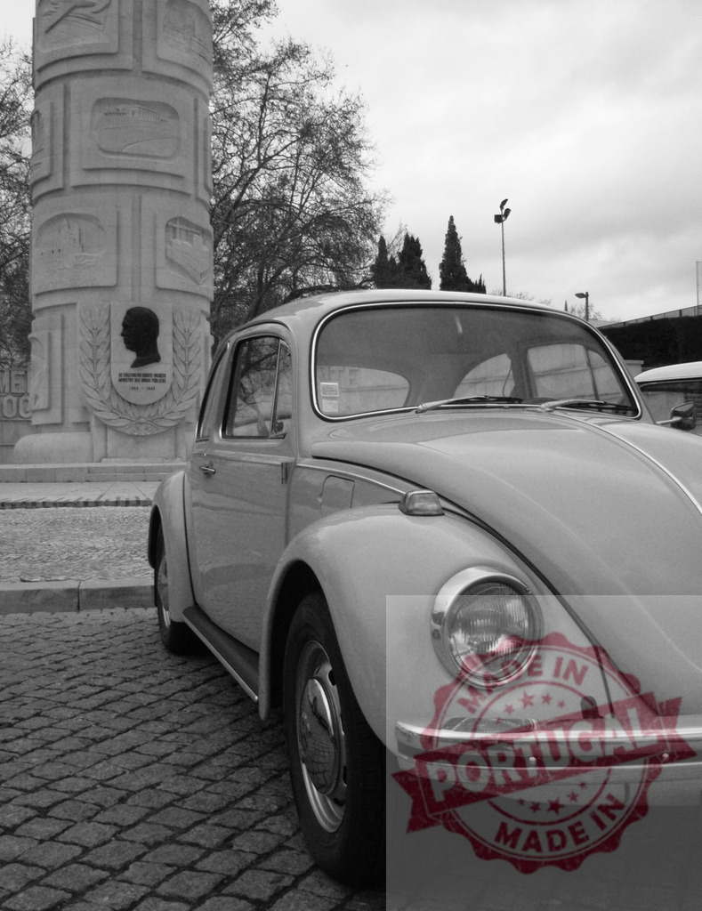 Classic Volkswagen Beetle parked near Padrão dos Descobrimentos in black and white | Vintage Volkswagen Beetle parked near Padrão dos Descobrimentos monument in Belém, Lisbon, Portugal, in monochrome - Realized with Pictrs.com