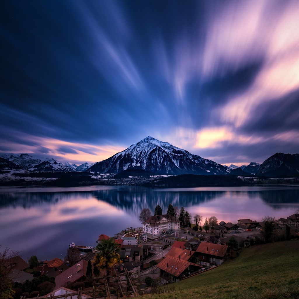 Hausberg | Langzeitaufnahme von Gunten über den Thunersee zum Niesen. Die Spiegelung des Bergs reicht über den ganzen See und scheint auf das Dorf zu zeigen. Durch die mit Graufilter verlängert Belichtungszeit werden die Wolkenbewegungen im Abendlicht sichtbar. 
------------------------------------------------------------
backyard mountain
Long exposure from Gunten across Lake Thun to the Niesen. The reflection of the mountain extends over the whole lake and seems to point to the village. Due to the extended exposure time with a gray filter, the cloud movements are visible in the evening light.
------------------------------------------------------------
Dieser Druck ist in einer limitierten Auflage von 5 Exemplaren erhältlich. 
This print is available in a limited edition of 5 copies. 
http://art.hess.photography/97-hausberg.html - Realisiert mit Pictrs.com