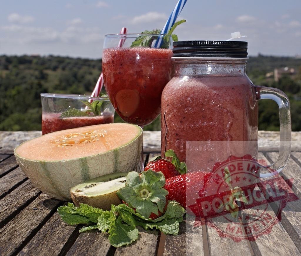 Refreshing strawberry melon kiwi fruit smoothies outdoors | Fresh strawberry, melon, kiwi, and mint smoothies serving on a rustic wooden table under sun - Realized with Pictrs.com