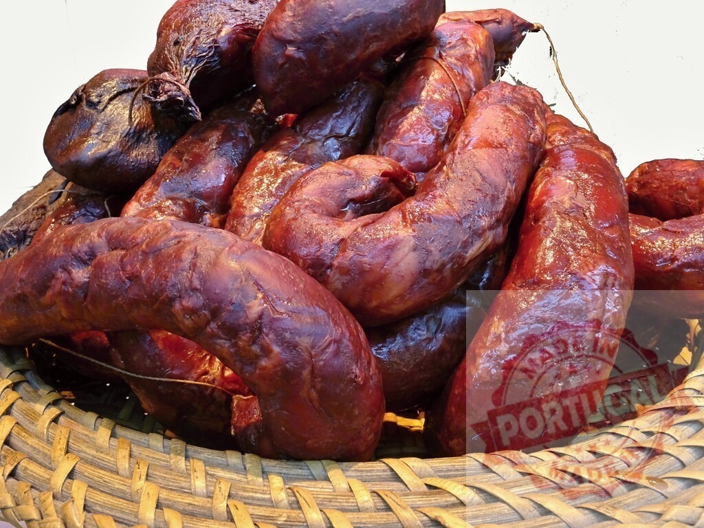 Smoked chorizo sausages in woven basket | Smoked chorizo sausages filling a rustic woven basket - Realized with Pictrs.com