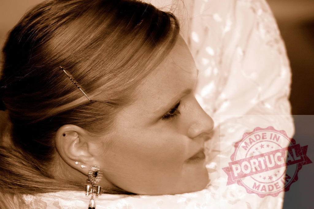 Woman wearing elegant hairstyle and earrings in sepia | Woman in profile wearing formal hairstyle and dangling earrings in sepia tone - Realized with Pictrs.com