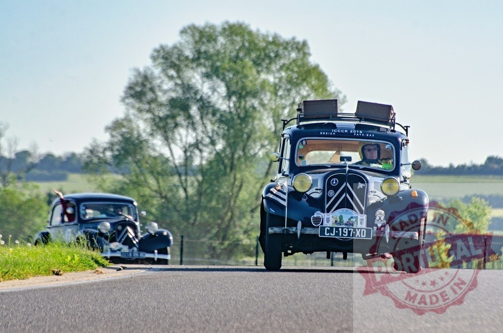 Citroën Traction Avant rally cars driving countryside road | Two vintage Citroën Traction Avant cars participate in a classic car rally through the countryside - Realized with Pictrs.com