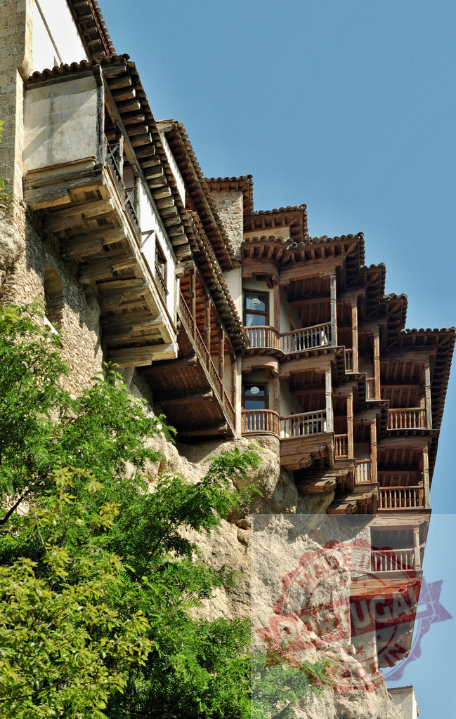 Casas Colgadas hanging houses on a Cuenca cliffside. Cuenca - Spain | Historical hanging houses of Cuenca built into a cliff, featuring wooden balconies and traditional architecture - Realized with Pictrs.com