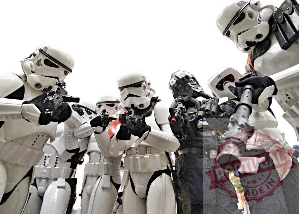 Imperial stormtroopers and tie fighter pilot holding weapons | Group of Star Wars costumed characters posing holding weapons - Realized with Pictrs.com