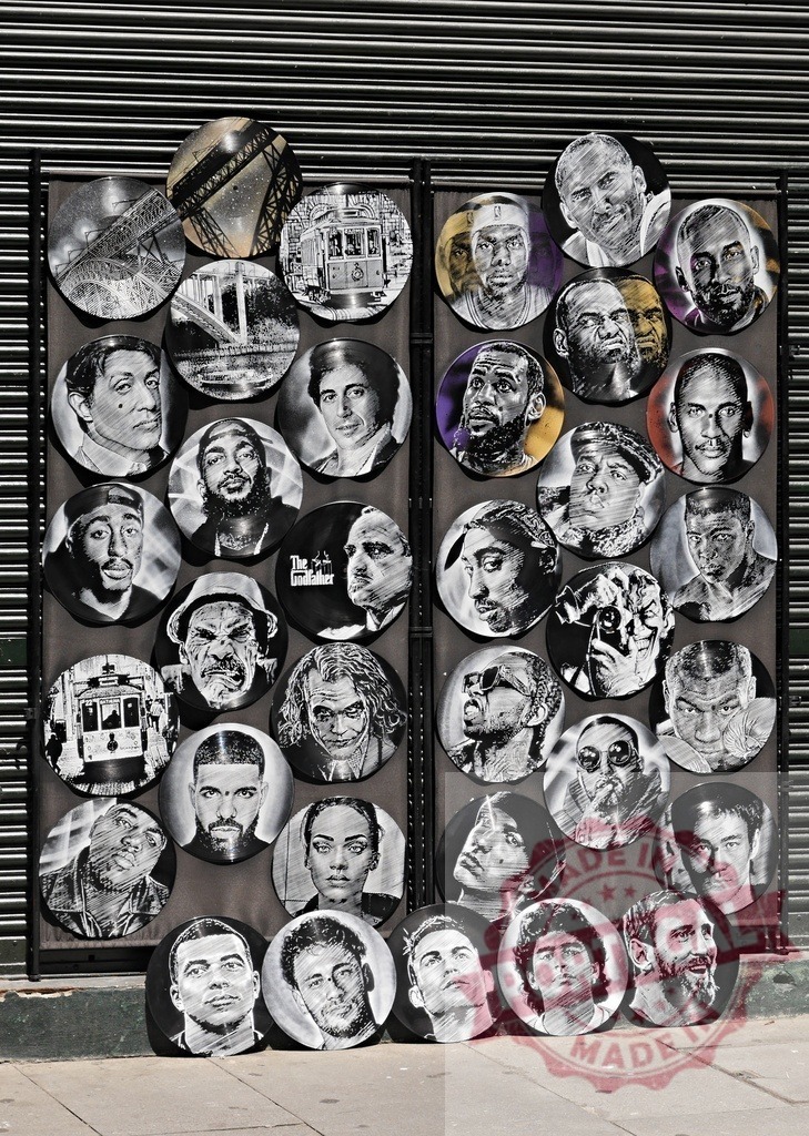 Vinyl records featuring pop culture and famous portraits | Collection of carved vinyl records displaying portraits of celebrities and cityscapes on a street stall - Realized with Pictrs.com