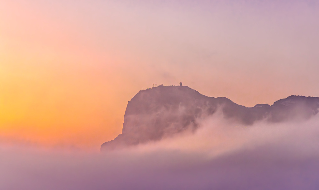 Sonnenaufgang im Nebel am Kalksteinfelsen von Gibraltar | Das Bild zeigt den Felsen von Gibraltar, bei SonnenaufgangMotiv: Der berühmte Kalksteinfelsen von Gibraltar, der markant aus einer dichten Wolkendecke (oft als „Levante-Wolke“ bekannt) bei Sonnenaufgang hervorragt.Verfügbarkeit: Es wird als Wandbild in verschiedenen Formaten und Materialien wie Alu-Dibond oder Acrylglas angeboten.Der Felsen von Gibraltar ist ein britisches Überseegebiet an der Südspitze der Iberischen Halbinsel und ein bekanntes Wahrzeichen für seine markante Form und die dort lebenden Berberaffen. - Realisiert mit Pictrs.com