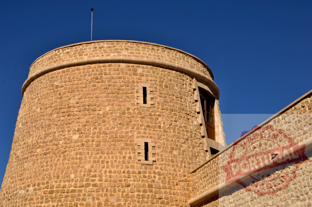 Riffa Fort stone turret against blue sky | Riffa Fort showing its old stonework and round tower under a clear sky - Realisiert mit Pictrs.com