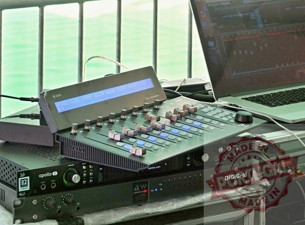 Professional audio mixing console and laptop controlling sound engineering equipment | Audio mixing console, laptop, and sound equipment set up for a professional sound engineer, ready for recording or live performance - Realized with Pictrs.com