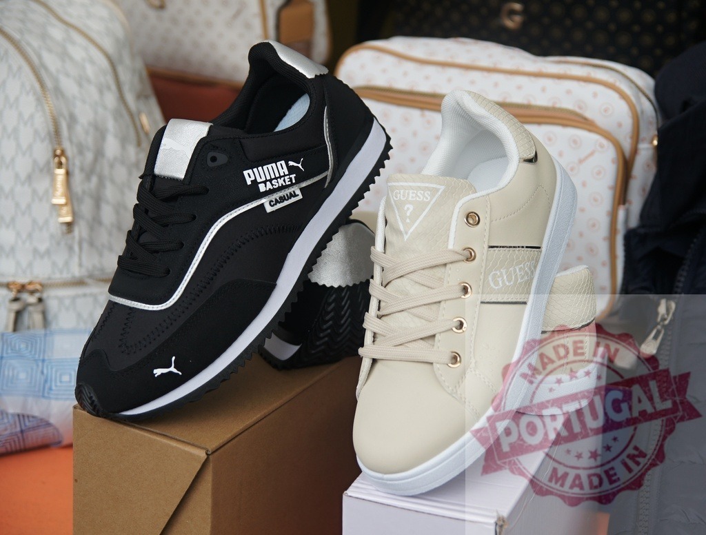 Puma and Guess sneakers representing fashion footwear | Two pairs of branded sneakers displayed on boxes in a retail setting - Realisiert mit Pictrs.com