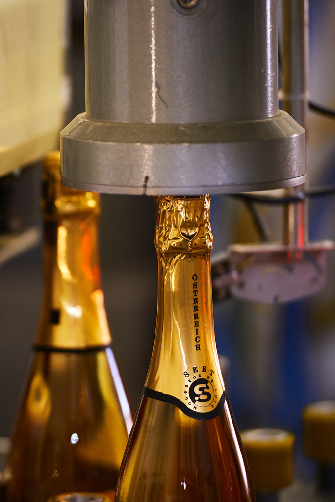 Sektkellerei Szigeti | Gols, Austria - February 19, 2018: Sektkellerei Szigeti; mehrere Sektflaschen mit Sekt-Kappen.  - Realisiert mit Pictrs.com