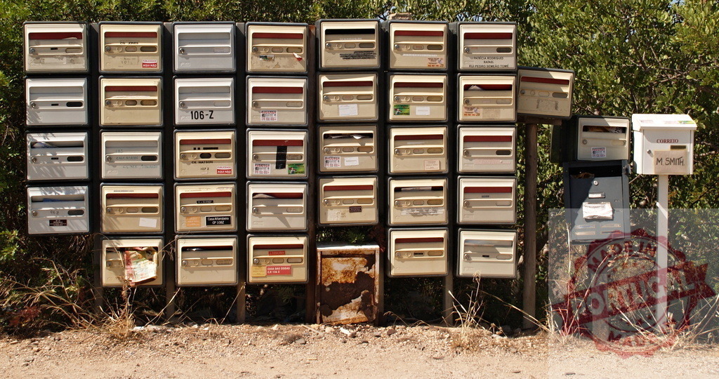 Cluster of mailboxes standing on a dirt road | Many mailboxes grouped together, creating a sense of community and communication in a remote area - Realized with Pictrs.com